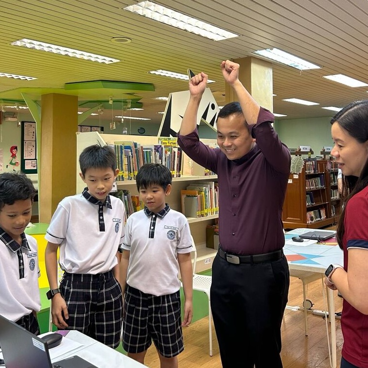 Students learning artificial intelligence and training machine learning models during an AI class at Bukit View Primary School in Singapore.