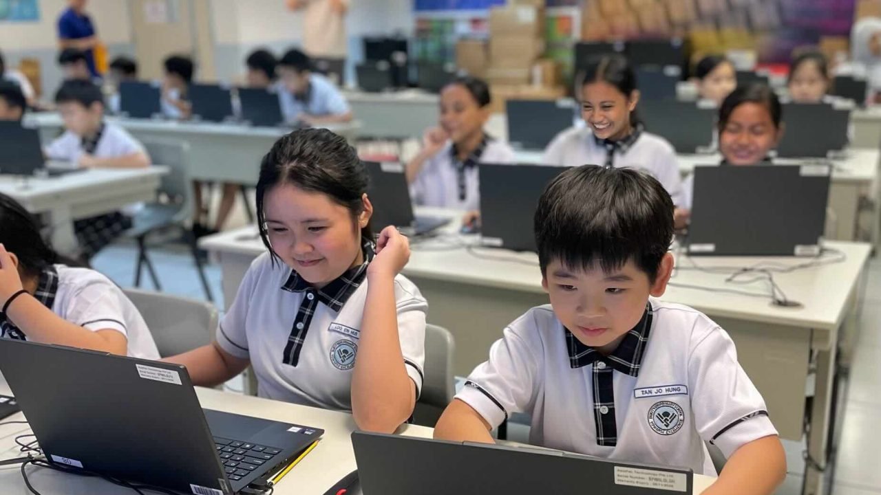 Students working on laptops in an AI class